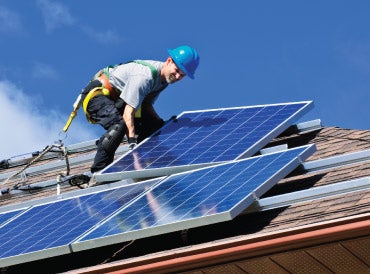 worker on a solar panel